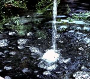 Artistic flow of water into pond